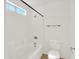 Bright bathroom featuring a shower-tub combination and a white toilet at 13620 N 82Nd Ln, Peoria, AZ 85381