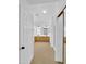 Bright hallway leads to the bathroom with tile floors, wood vanity and mirrored shower at 13620 N 82Nd Ln, Peoria, AZ 85381