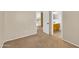 Neutral bedroom with beige carpet leads to an ensuite bathroom and upstairs landing at 13620 N 82Nd Ln, Peoria, AZ 85381