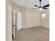 Neutral bedroom features a ceiling fan, carpet, and door to adjoining room and closet at 13620 N 82Nd Ln, Peoria, AZ 85381