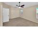 Neutral bedroom features a ceiling fan, carpeted floors, and large windows at 13620 N 82Nd Ln, Peoria, AZ 85381