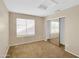 Cozy bedroom with neutral carpet, closet with mirrored doors, and bright natural light at 13620 N 82Nd Ln, Peoria, AZ 85381