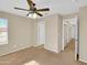 Spacious bedroom featuring a ceiling fan and ample natural light from the large windows at 13620 N 82Nd Ln, Peoria, AZ 85381