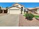 Charming single-Gathering home featuring stucco facade, attached two-car garage, and desert landscaping in front yard at 13620 N 82Nd Ln, Peoria, AZ 85381
