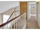 Bright hallway with white railings, light brown walls, and a built-in storage cabinet at 13620 N 82Nd Ln, Peoria, AZ 85381