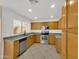 Kitchen featuring granite countertops, stainless steel appliances, and wood cabinetry at 13620 N 82Nd Ln, Peoria, AZ 85381
