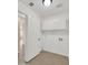 Laundry room with built-in cabinets and shelving for storage at 13620 N 82Nd Ln, Peoria, AZ 85381