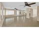 Large open living space featuring tile floors, ceiling fans, sliding glass doors, and lots of natural light at 13620 N 82Nd Ln, Peoria, AZ 85381