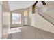 Inviting living room with tile flooring, high ceilings, a ceiling fan, natural light, and staircase at 13620 N 82Nd Ln, Peoria, AZ 85381