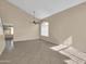 Spacious living room with tile flooring, high ceilings, neutral paint, a ceiling fan, and abundant natural light at 13620 N 82Nd Ln, Peoria, AZ 85381