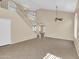 Bright living room featuring high ceilings, tile floors, and large staircase to the second story at 13620 N 82Nd Ln, Peoria, AZ 85381