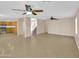 Large open living space with a tile floor, high ceilings, lots of natural light, and open access to other rooms at 13620 N 82Nd Ln, Peoria, AZ 85381