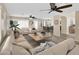 Spacious living room featuring neutral tones, ceiling fans, modern decor, and an open floor plan at 13620 N 82Nd Ln, Peoria, AZ 85381
