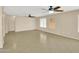 Open-concept living room featuring tile floors, bright natural light, and a ceiling fan at 13620 N 82Nd Ln, Peoria, AZ 85381