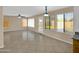 Bright living room featuring tile flooring, ceiling fans and multiple windows offering ample natural light at 13620 N 82Nd Ln, Peoria, AZ 85381