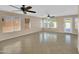 Bright living room featuring tile flooring, ceiling fans and multiple windows offering ample natural light at 13620 N 82Nd Ln, Peoria, AZ 85381