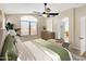 Relaxing main bedroom showcasing a decorative ceiling fan, ample natural light, and calming decor at 13620 N 82Nd Ln, Peoria, AZ 85381
