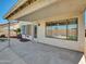 Covered patio for outdoor dining & relaxation, with large windows providing views of the backyard at 13620 N 82Nd Ln, Peoria, AZ 85381