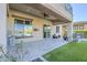 Covered patio area with tiled flooring, ceiling fan, and outdoor kitchen view at 15711 S 11Th Ave, Phoenix, AZ 85045