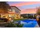 Inviting backyard with a pool, covered patio, grill, and turf at 15711 S 11Th Ave, Phoenix, AZ 85045