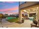 Inviting backyard with a pool, manicured lawn, and covered patio seating for outdoor entertaining at 15711 S 11Th Ave, Phoenix, AZ 85045