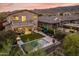 Aerial view of a backyard featuring a swimming pool, patio, outdoor kitchen, and lush landscaping at 15711 S 11Th Ave, Phoenix, AZ 85045
