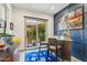Stylish bar area with seating, modern decor, and a view of the outdoor landscape through sliding glass doors at 15711 S 11Th Ave, Phoenix, AZ 85045