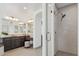 Bathroom showcasing dark wood cabinets, tiled shower, and light tile flooring at 15711 S 11Th Ave, Phoenix, AZ 85045
