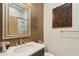 Modern bathroom with stylish fixtures, a walk-in shower, and a decorative mirror at 15711 S 11Th Ave, Phoenix, AZ 85045