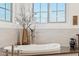 Modern soaking tub with fixtures, set against bright windows and white subway tile, offering a spa-like retreat at 15711 S 11Th Ave, Phoenix, AZ 85045