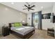 A comfortable bedroom with neutral tones, a ceiling fan, and natural light from the window at 15711 S 11Th Ave, Phoenix, AZ 85045