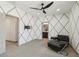 Stylish bedroom with carpet floors, modern ceiling fan, and gray accent wall design at 15711 S 11Th Ave, Phoenix, AZ 85045