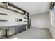 Spacious room featuring built-in shelves and cabinets, creating a flexible space for entertainment or a home office at 15711 S 11Th Ave, Phoenix, AZ 85045