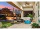 Comfortable patio with a fire pit, turf, and cozy furniture at 15711 S 11Th Ave, Phoenix, AZ 85045