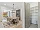 Bright dining room features modern chandelier, dining table and chairs, with wine storage at 15711 S 11Th Ave, Phoenix, AZ 85045