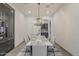 Bright dining room featuring modern chandelier and view into the kitchen at 15711 S 11Th Ave, Phoenix, AZ 85045