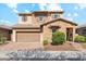 Beautiful two-story home featuring a stone facade, a two-car garage, and manicured landscaping at 15711 S 11Th Ave, Phoenix, AZ 85045