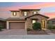 Charming two-story home with a stone facade, well-maintained landscaping, and a two-car garage at 15711 S 11Th Ave, Phoenix, AZ 85045