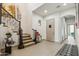 Bright foyer features a staircase, elegant console table, and a cushioned bench, creating a welcoming entry at 15711 S 11Th Ave, Phoenix, AZ 85045