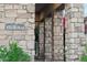 Inviting front entrance with stone columns, a visible house number, and lush foliage creating curb appeal at 15711 S 11Th Ave, Phoenix, AZ 85045