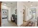 Bright hallway with arched doorways, neutral tones, and a convenient office nook, offering a functional living space at 15711 S 11Th Ave, Phoenix, AZ 85045