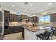 Modern kitchen with a large island, stainless steel appliances, and a patterned tile backsplash at 15711 S 11Th Ave, Phoenix, AZ 85045