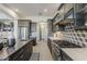 Spacious kitchen featuring stainless appliances, modern backsplash, a center island, and ample counter space at 15711 S 11Th Ave, Phoenix, AZ 85045