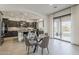 Open-concept kitchen features dark cabinetry, a large island, and a seamless flow into the dining area at 15711 S 11Th Ave, Phoenix, AZ 85045