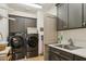 Laundry room features Samsung washer/dryer, a laundry sink, and cabinet storage at 15711 S 11Th Ave, Phoenix, AZ 85045