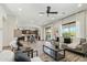 Open-concept living room with modern furniture, flowing into the kitchen and with access to outdoor space at 15711 S 11Th Ave, Phoenix, AZ 85045
