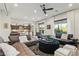 Open-concept living area with stylish furnishings, an ottoman, and seamless flow to the kitchen at 15711 S 11Th Ave, Phoenix, AZ 85045