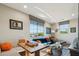 A stylish and comfortable living room with colorful decor and large picture windows at 15711 S 11Th Ave, Phoenix, AZ 85045