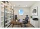 Bright home office with custom shelving provides an ideal workspace with natural lighting at 15711 S 11Th Ave, Phoenix, AZ 85045
