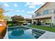 Inviting pool with an outdoor living space, grill, and turf at 15711 S 11Th Ave, Phoenix, AZ 85045